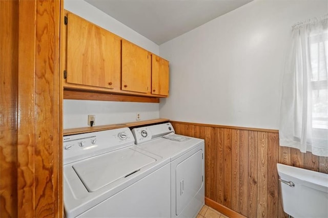 1212 E 22nd Ave, North Kansas City, MO 64116 - washroom with washing machine and clothes dryer, wooden walls, and a wainscoted wall