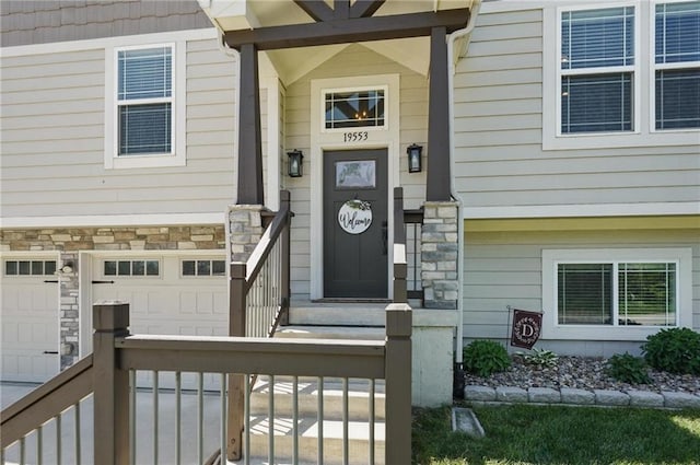 19553 E 14th St N, Independence, MO 64056 - entrance to property with stone siding, an attached garage, and driveway