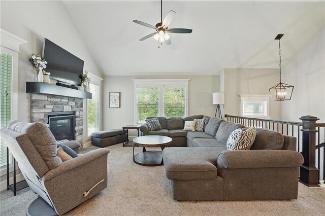19553 E 14th St N, Independence, MO 64056 - living area featuring carpet flooring, a fireplace, ceiling fan, high vaulted ceiling, and a chandelier