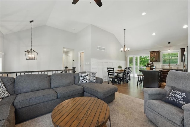 19553 E 14th St N, Independence, MO 64056 - living area featuring a chandelier, ceiling fan, high vaulted ceiling, wood finished floors, and recessed lighting