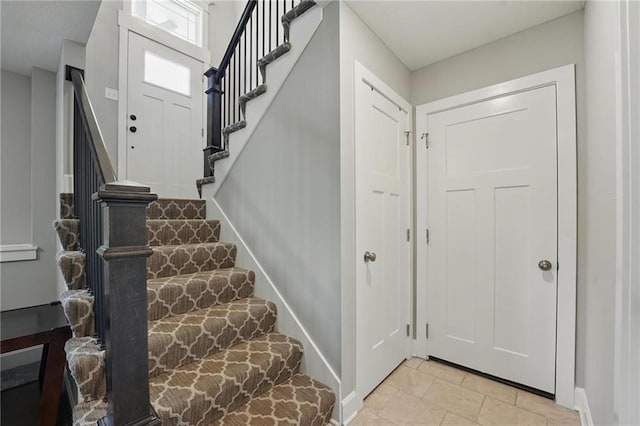 19553 E 14th St N, Independence, MO 64056 - entryway featuring stairway, light tile patterned floors, and baseboards