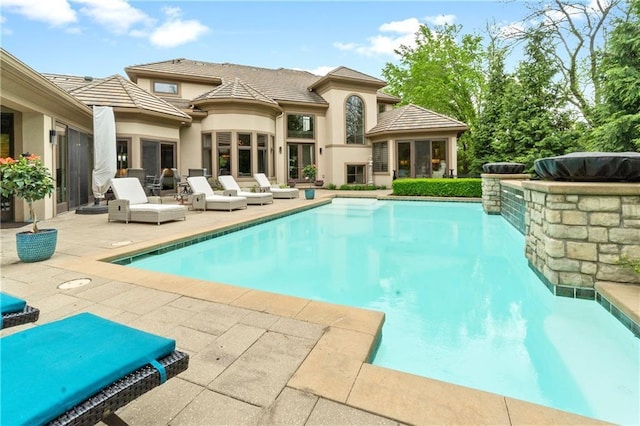 14160 Juniper St, Leawood, KS 66224 - back of house featuring a patio area, an outdoor pool, stucco siding, and a tile roof