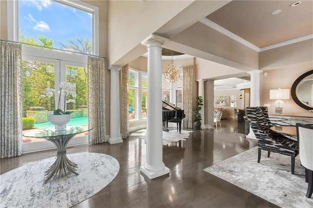 14160 Juniper St, Leawood, KS 66224 - foyer with decorative columns, healthy amount of natural light, a towering ceiling, crown molding, and a chandelier