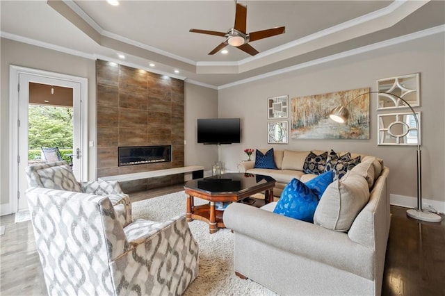 14160 Juniper St, Leawood, KS 66224 - living area with a raised ceiling, crown molding, ceiling fan, a fireplace, and recessed lighting