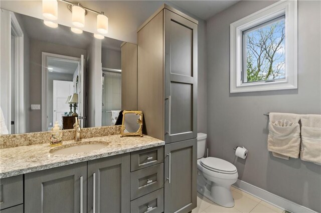 14160 Juniper St, Leawood, KS 66224 - bathroom featuring toilet, baseboards, tile patterned flooring, and vanity