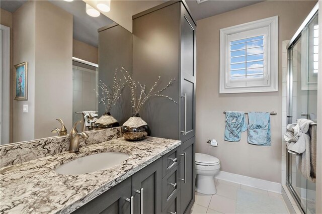 14160 Juniper St, Leawood, KS 66224 - bathroom with a stall shower, baseboards, vanity, and toilet