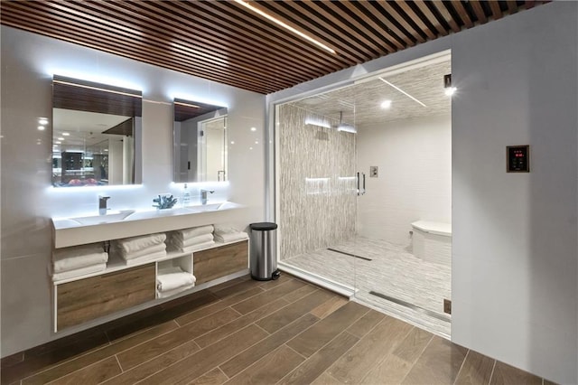14160 Juniper St, Leawood, KS 66224 - bathroom with a shower stall, wood finished floors, and double vanity
