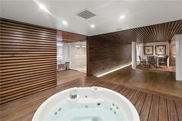 14160 Juniper St, Leawood, KS 66224 - bathroom featuring a jetted tub and wood finished floors