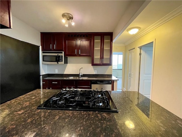 700 E 8th St Unit 10J, Kansas City, MO 64106 - kitchen with stainless steel appliances, a sink, glass insert cabinets, crown molding, and dark stone countertops