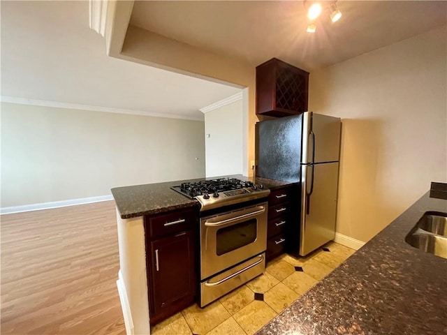 700 E 8th St Unit 10J, Kansas City, MO 64106 - kitchen with stainless steel appliances, crown molding, dark stone counters, baseboards, and a peninsula