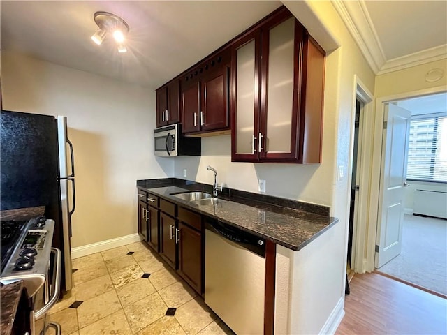 700 E 8th St Unit 10J, Kansas City, MO 64106 - kitchen featuring a sink, stainless steel appliances, crown molding, dark stone counters, and glass insert cabinets