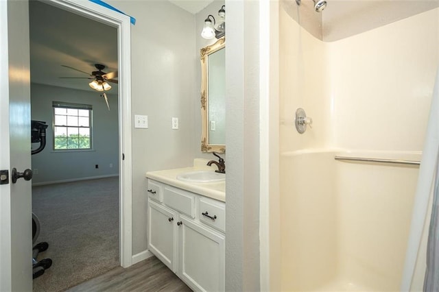 3668 Colorado Rd, Pomona, KS 66076 - bathroom featuring a shower, vanity, a ceiling fan, and baseboards