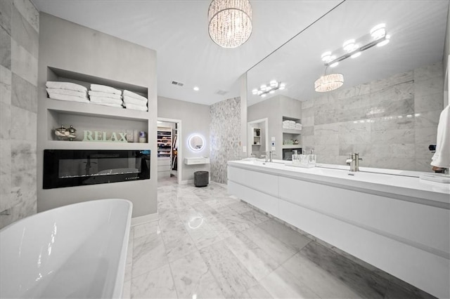 5645 Legler St, Shawnee, KS 66217 - bathroom with double vanity, a freestanding tub, marble finish floors, a spacious closet, and tile walls