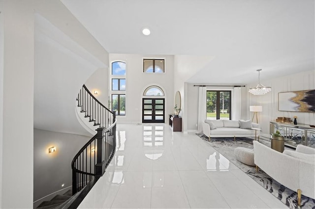 5645 Legler St, Shawnee, KS 66217 - tiled foyer featuring stairway and a chandelier