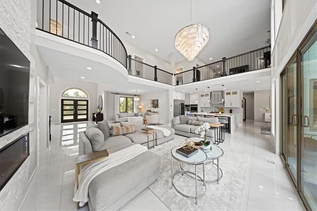 5645 Legler St, Shawnee, KS 66217 - living room featuring a towering ceiling, a chandelier, and light tile patterned floors