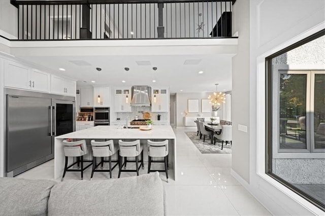5645 Legler St, Shawnee, KS 66217 - kitchen with stainless steel appliances, white cabinetry, glass insert cabinets, tasteful backsplash, and a high ceiling