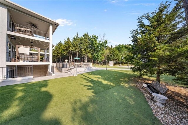 5645 Legler St, Shawnee, KS 66217 - view of green lawn with a ceiling fan, a balcony, and a patio area