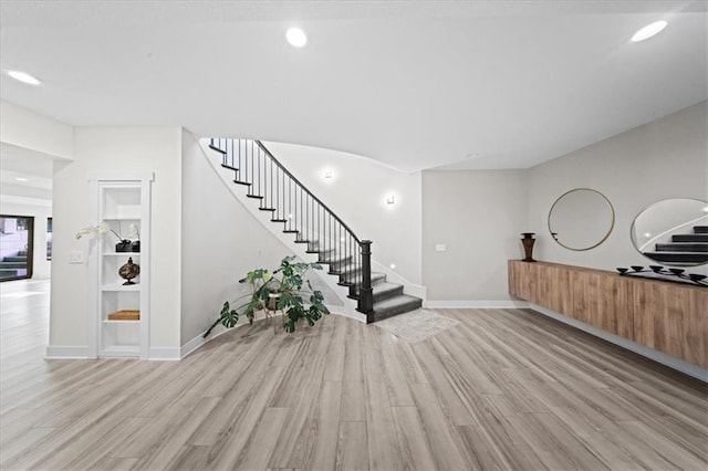5645 Legler St, Shawnee, KS 66217 - entrance foyer with stairway, light wood finished floors, and recessed lighting