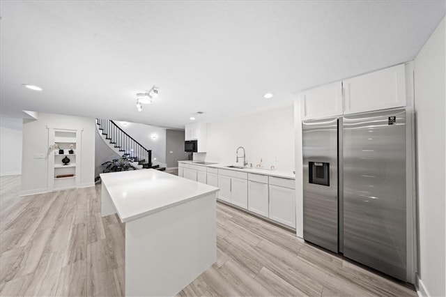 5645 Legler St, Shawnee, KS 66217 - kitchen with black appliances, white cabinetry, a center island, light countertops, and recessed lighting