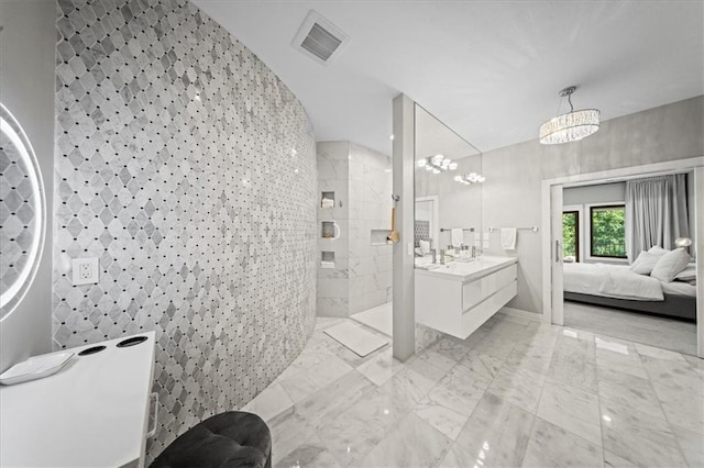 5645 Legler St, Shawnee, KS 66217 - bathroom featuring a walk in shower, vanity, marble finish floors, and connected bathroom