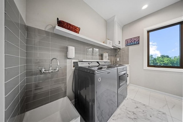 5645 Legler St, Shawnee, KS 66217 - washroom with independent washer and dryer, cabinet space, light marble finish flooring, and recessed lighting
