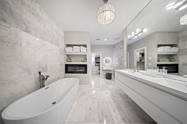 5645 Legler St, Shawnee, KS 66217 - full bath with marble finish floors, a freestanding tub, built in features, double vanity, and tile walls