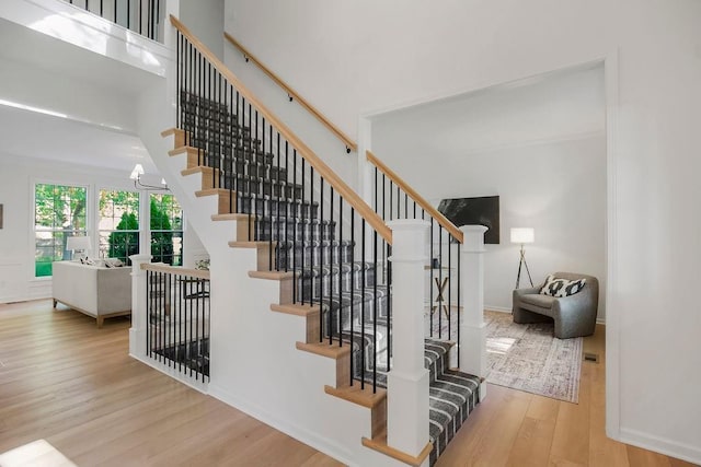 stairs with wood finished floors and baseboards