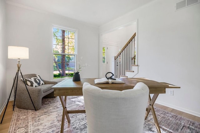 sitting room featuring stairway, crown molding, wood finished floors, and baseboards