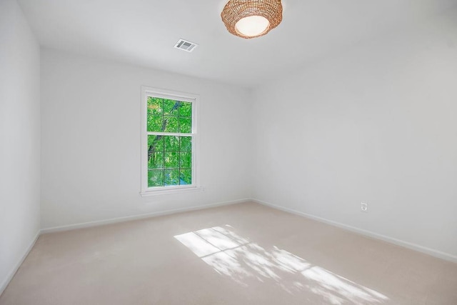 carpeted empty room with baseboards