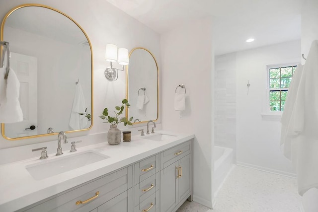 bathroom with double vanity and recessed lighting