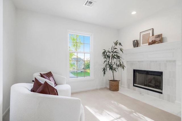 living area with a fireplace, recessed lighting, baseboards, and carpet