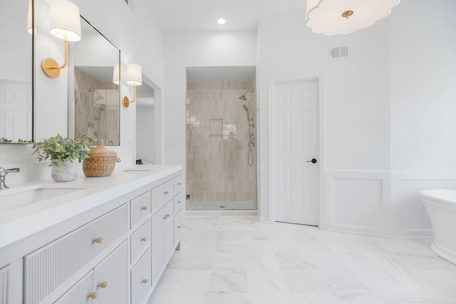bathroom with a shower stall, double vanity, and marble finish floors