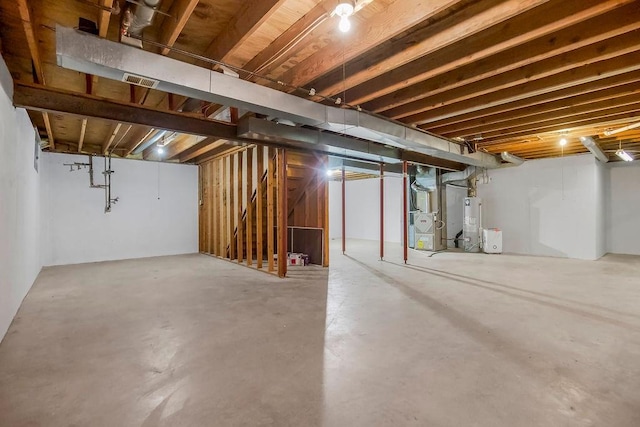 unfinished basement with heating unit, stairs, and water heater