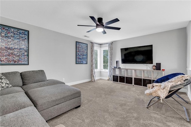 living room featuring a ceiling fan, carpet, and baseboards