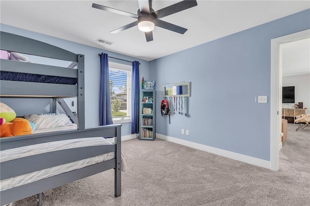 carpeted bedroom with baseboards and ceiling fan