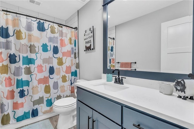 full bathroom with toilet, vanity, and curtained shower