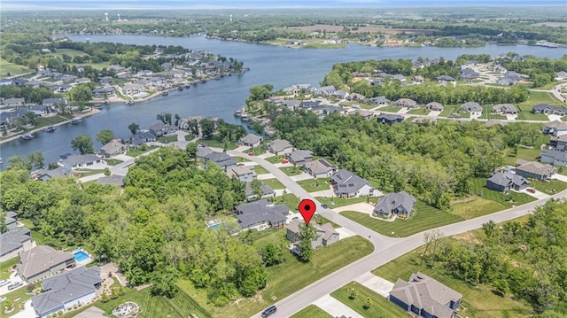 aerial view of property and surrounding area with nearby suburban area and a large body of water