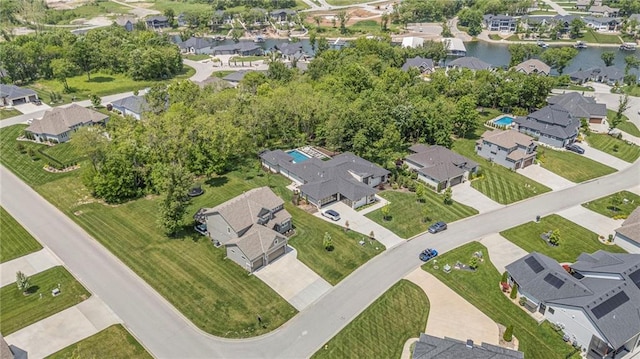 aerial view of property's location featuring nearby suburban area and a large body of water