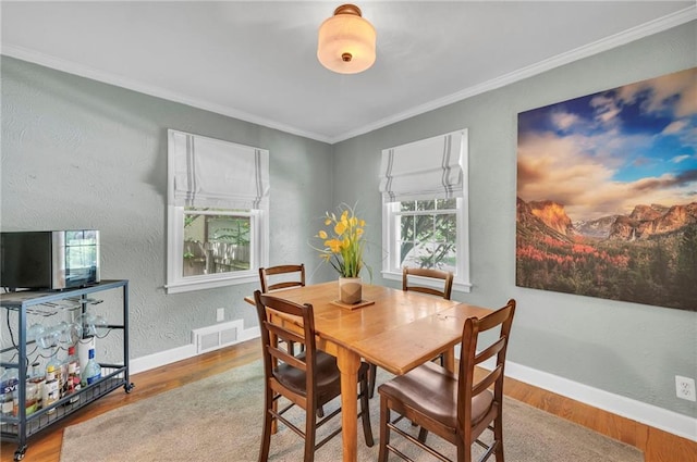 7126 Charlotte St, Kansas City, MO 64131 - dining area featuring wood finished floors, baseboards, and ornamental molding