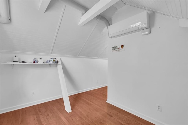 7126 Charlotte St, Kansas City, MO 64131 - laundry room featuring baseboards, wood finished floors, and an AC wall unit