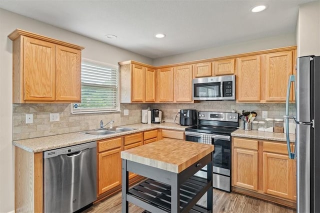 4700 E 136th Ct, Grandview, MO 64030 - kitchen featuring appliances with stainless steel finishes, a sink, light brown cabinetry, light wood-style flooring, and recessed lighting
