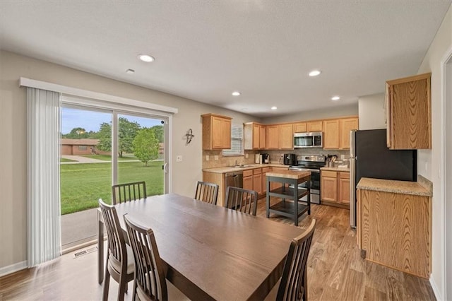 4700 E 136th Ct, Grandview, MO 64030 - dining space with light wood finished floors, recessed lighting, and baseboards