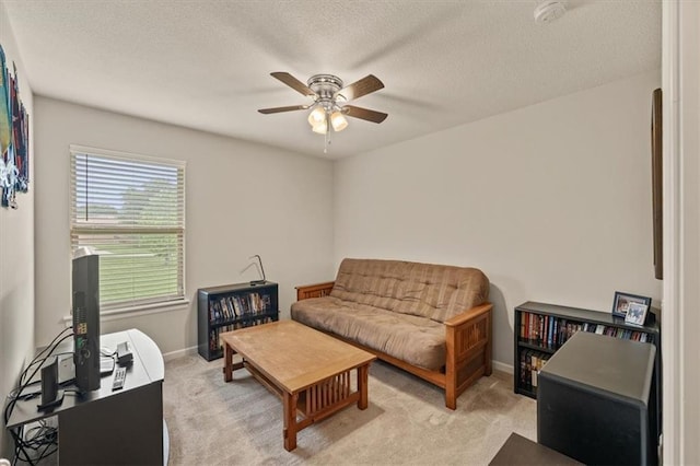 4700 E 136th Ct, Grandview, MO 64030 - living area featuring ceiling fan, light colored carpet, a textured ceiling, baseboards, and a desk