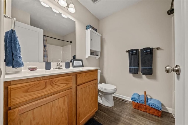 4700 E 136th Ct, Grandview, MO 64030 - bathroom featuring vanity, toilet, a shower with curtain, baseboards, and wood finished floors