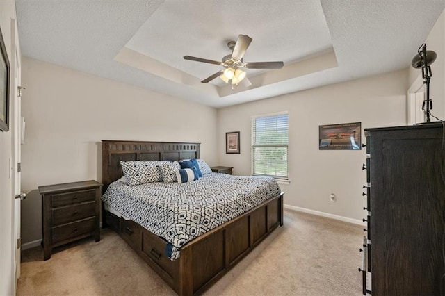 4700 E 136th Ct, Grandview, MO 64030 - bedroom with light carpet, a tray ceiling, baseboards, a ceiling fan, and a textured ceiling