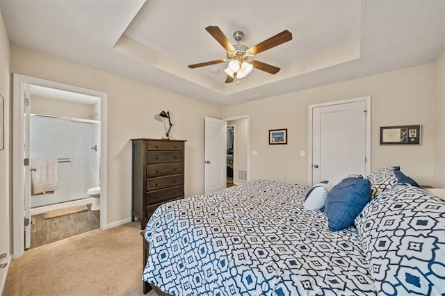4700 E 136th Ct, Grandview, MO 64030 - carpeted bedroom with a raised ceiling, a ceiling fan, connected bathroom, and baseboards