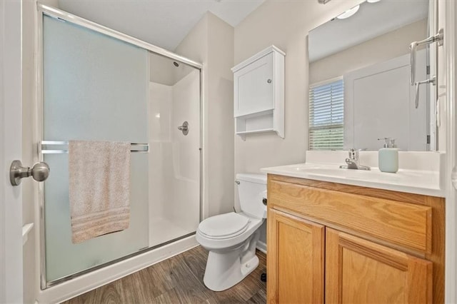 4700 E 136th Ct, Grandview, MO 64030 - full bathroom featuring a stall shower, toilet, vanity, and wood finished floors