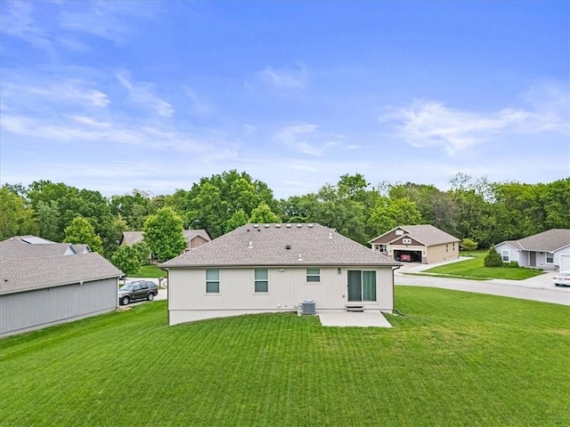 4700 E 136th Ct, Grandview, MO 64030 - back of house with a yard, a patio, central AC unit, and a chimney