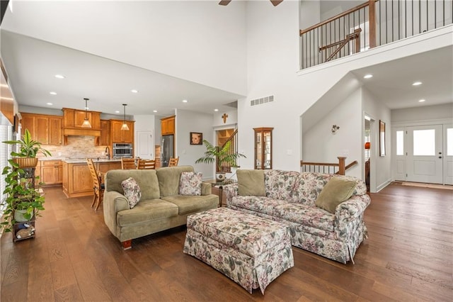 living room with dark wood finished floors, ceiling fan, and recessed lighting