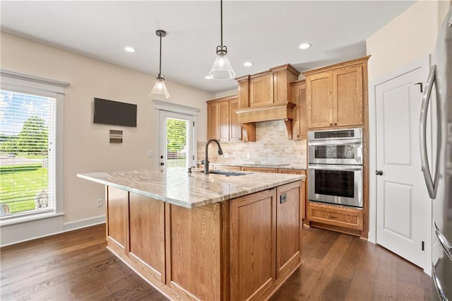 kitchen featuring a sink, appliances with stainless steel finishes, backsplash, dark wood-style flooring, and recessed lighting